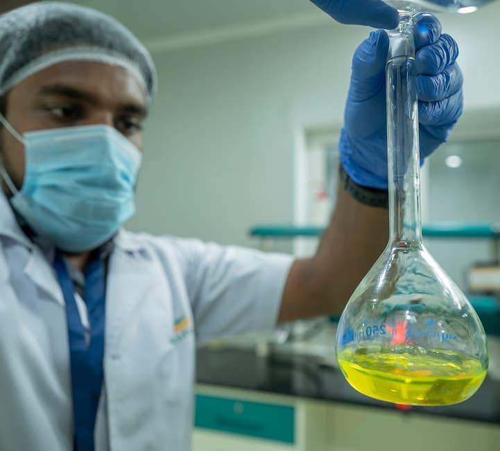 Quality-control technician testing turmeric extract at Terova processing facility